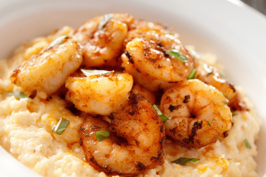 bowl of shrimp and grits topped with green onions